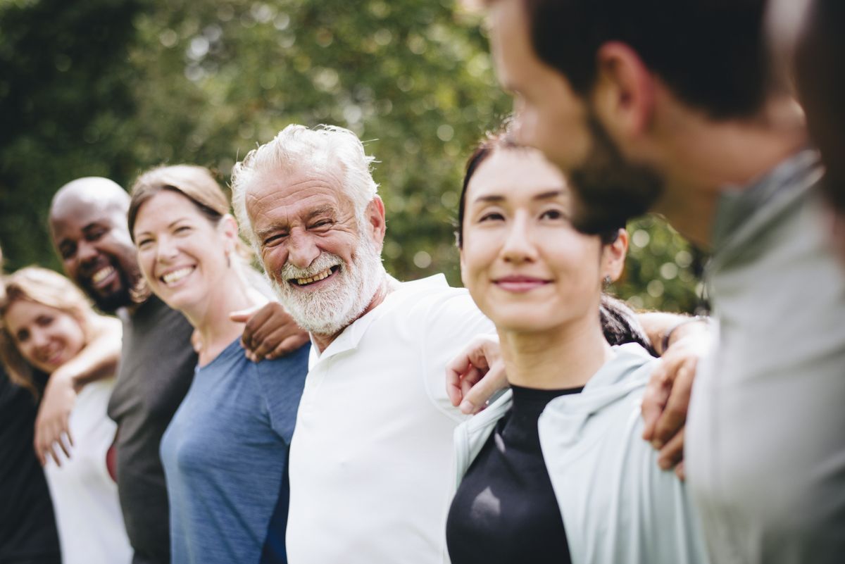 A diverse group of friends standing together in a park